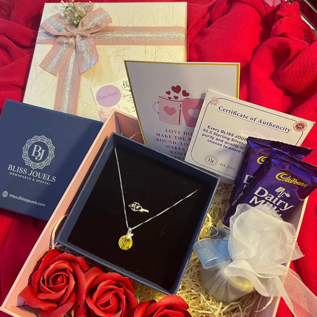 Valentine Hamper: A gift box with a necklace, roses, a handwritten love letter, scented candle, flowers, and chocolates.