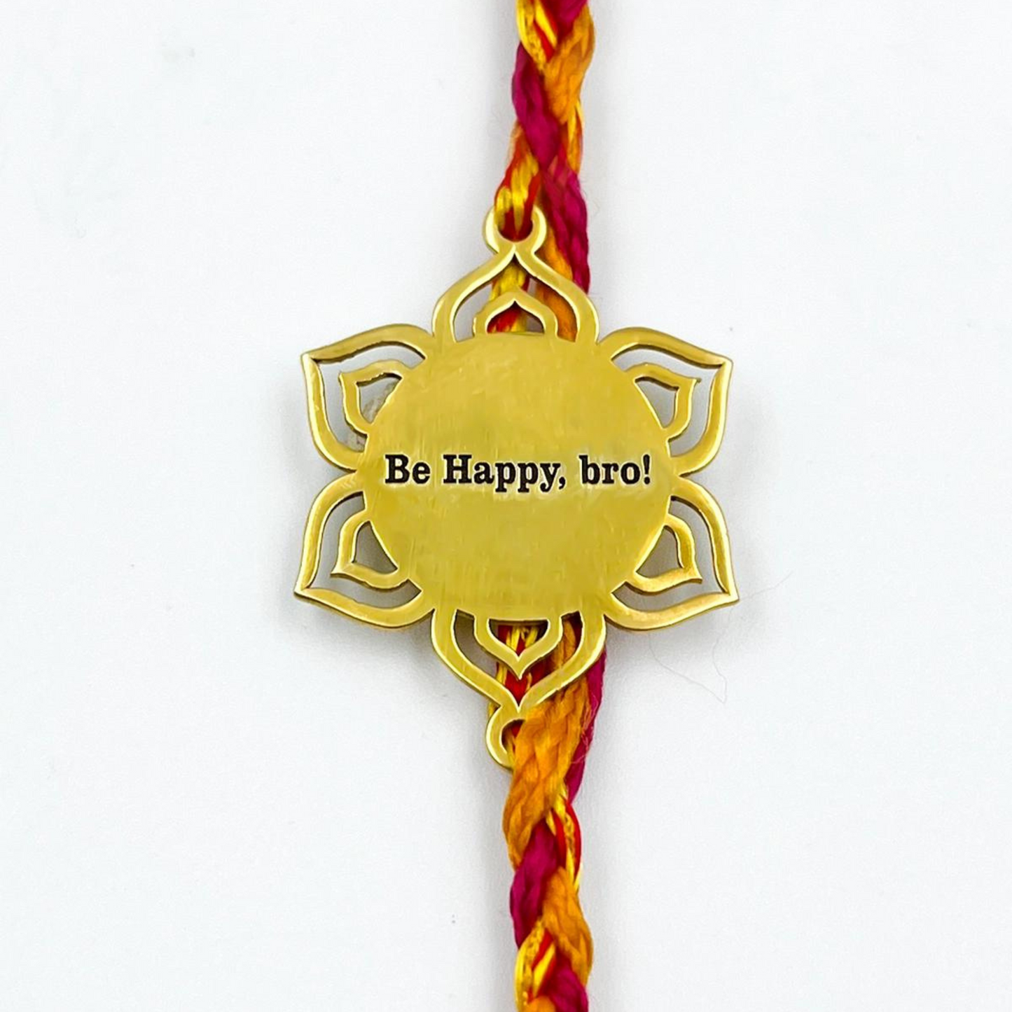 Golden Mandala Rakhi by Bliss Jouels, featuring an engraved Be Happy, bro! medallion on a multicolor thread, perfect for Raksha Bandhan celebrations.