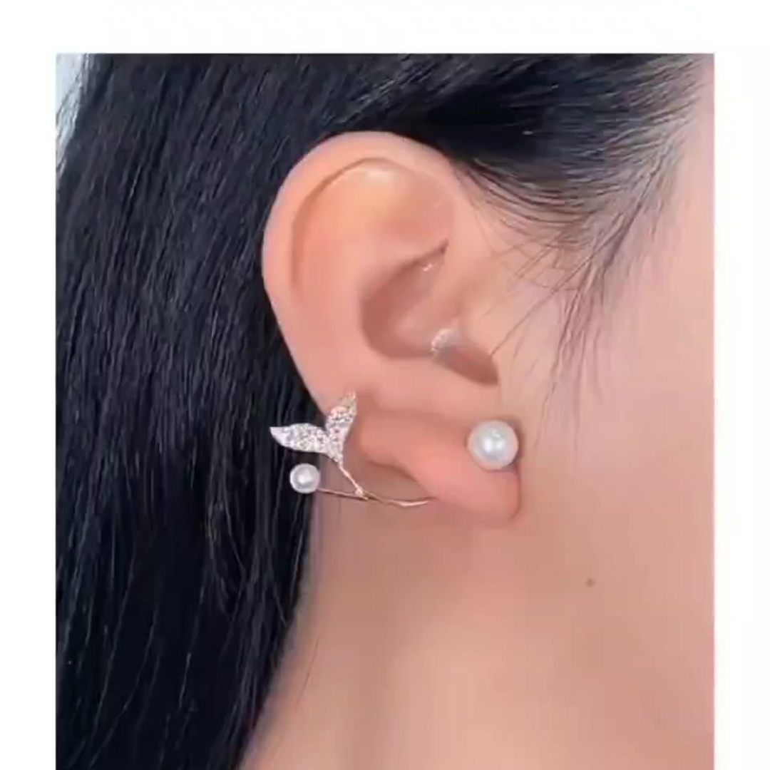 Close-up of a woman wearing Leaf Pearl Earrings, showcasing their elegant design with a pearl accent, made of 925 sterling silver.